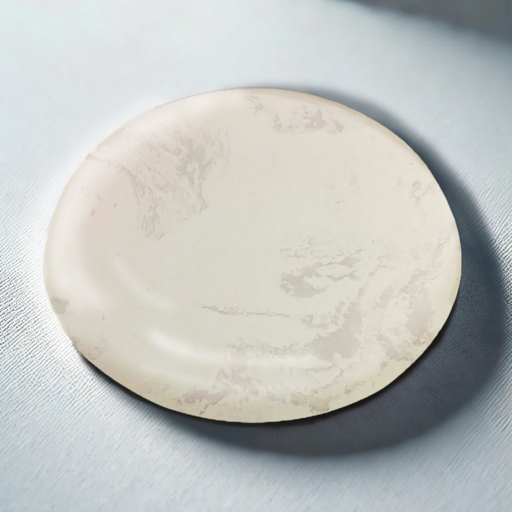 Round beige stone on a light gray background